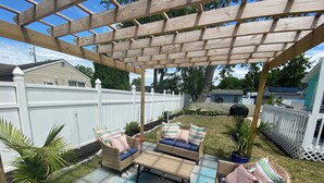 An outdoor patio with wicker furniture, a fire pit, and a pergola. - NEW LISTING!!!  Villas Quaint Coastal Cottage short drive to Beaches (Lower Township)