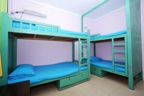 A bunk bed room with two bunk beds, each with a ladder, a small drawer, and a blue mattress. - Shiguanguyi Youth Inn (Guilin)