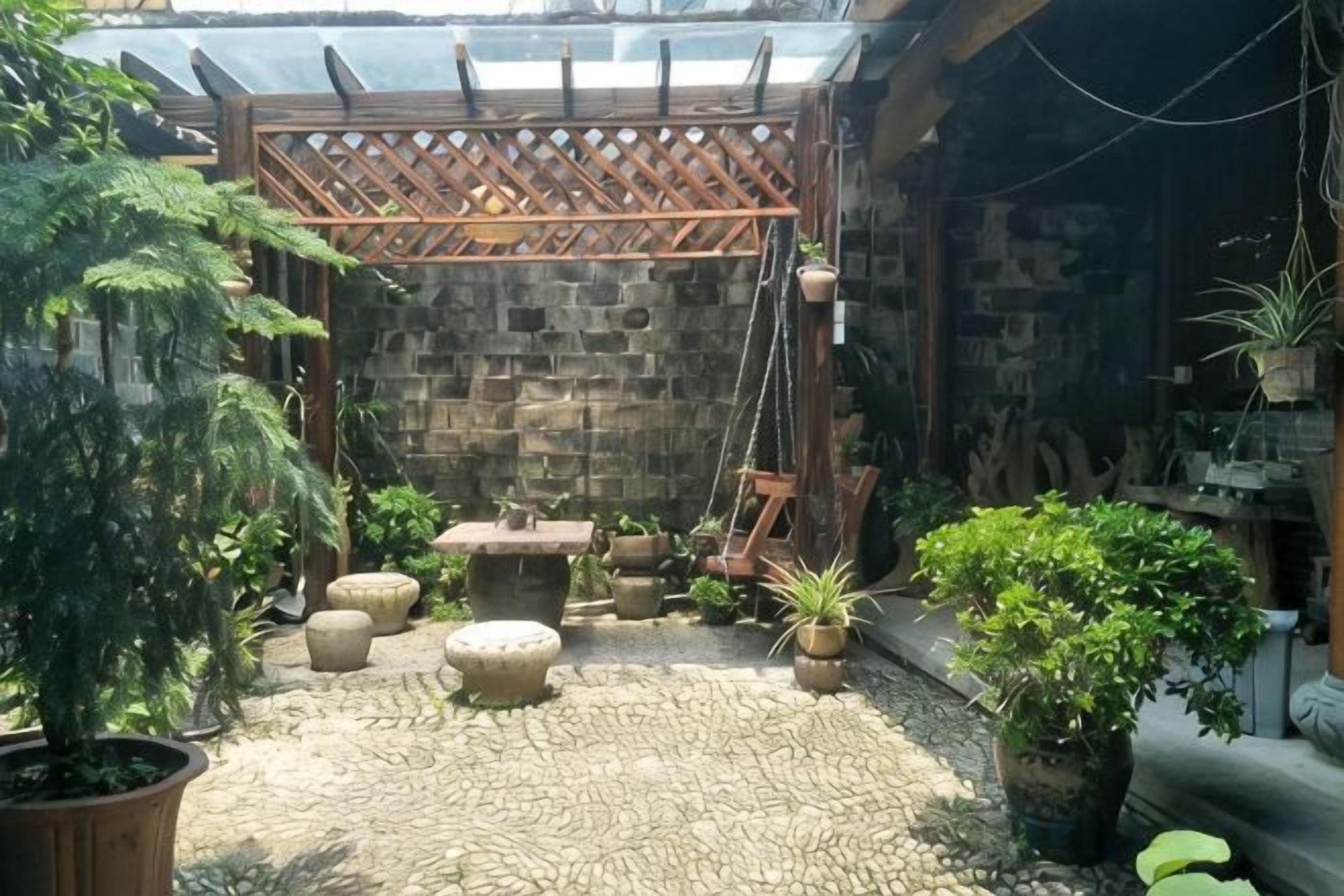 A stone-floored patio with a wooden swing set, potted plants, and a hanging plant.