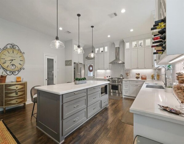 Enjoy cooking in this well-lit kitchen with a large island and stainless steel range.