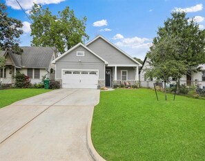 Stroll up to the charming entrance of this cozy home, featuring a gabled roof and inviting front porch.