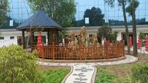 A traditional pavilion with a tiled walkway, surrounded by a wooden fence and red lanterns. - Baotianman Shanshui Inn (Neixiang)