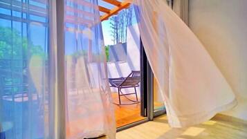 A room with a sliding glass door leading to an outdoor seating area.