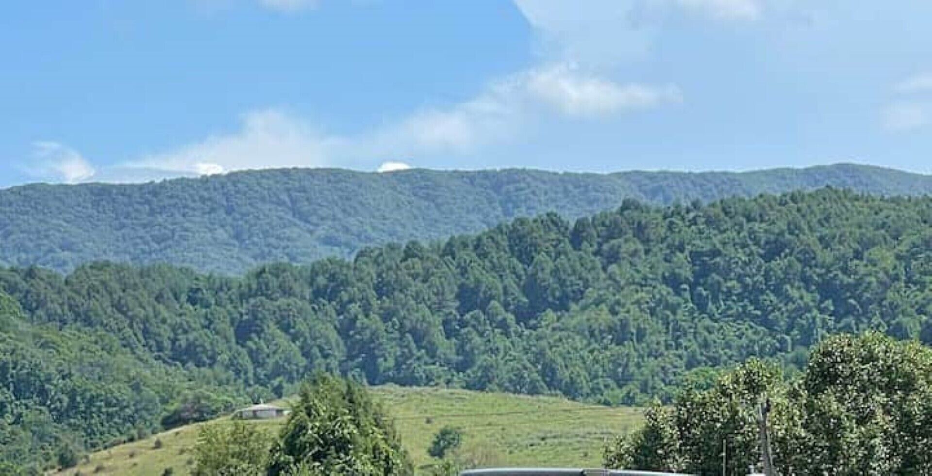 A mountainous landscape with dense forest coverage.
