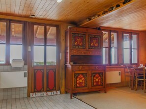 Cozy room with a large cabinet, tiled floor, and a window for natural light.