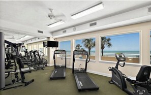 A gym with treadmills, stationary bikes, and weight machines.