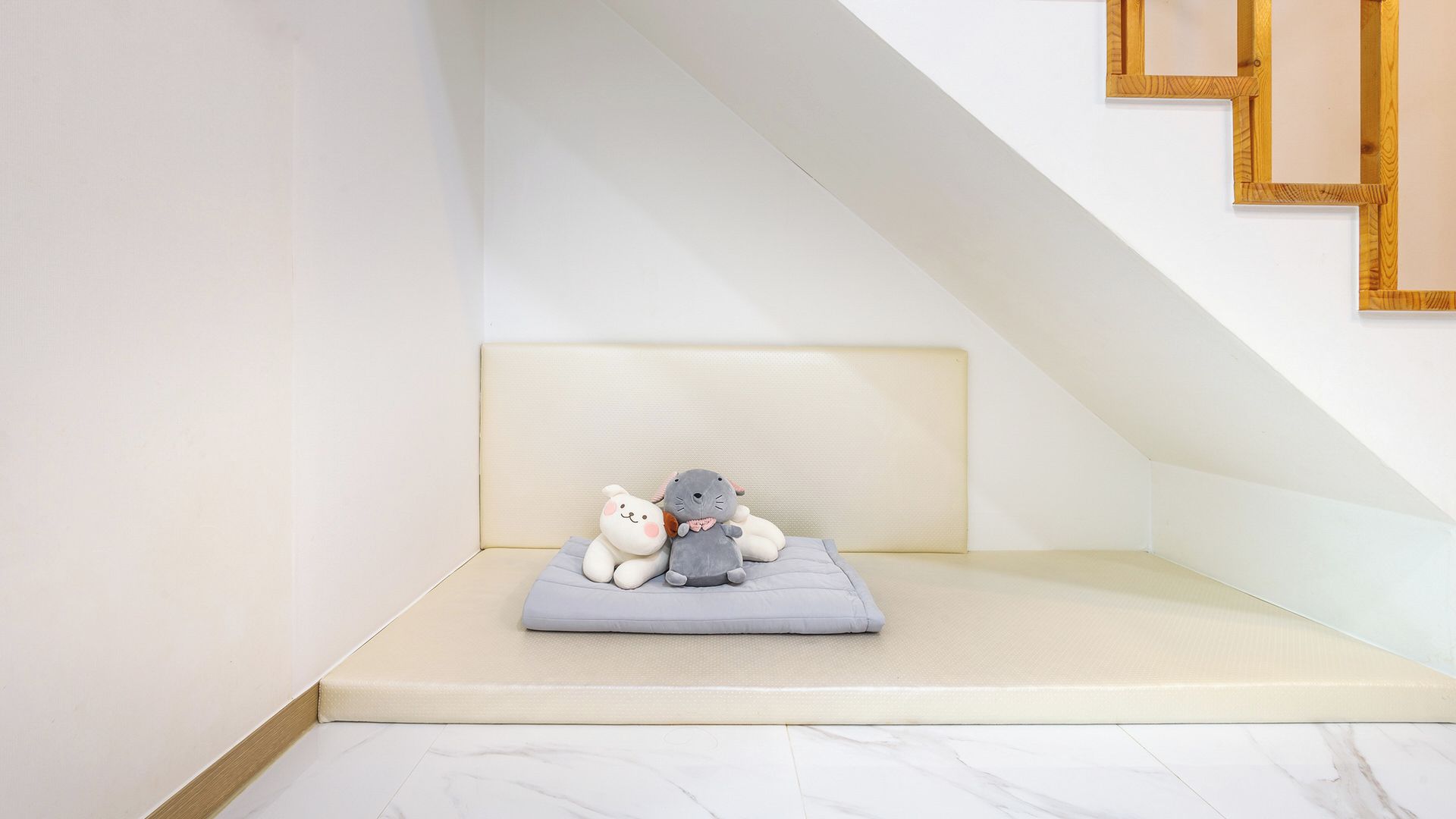 A small, cozy room with a sloped ceiling and a built-in bench.
