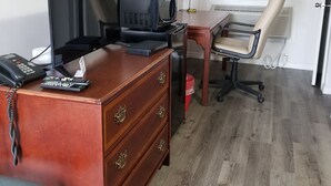 A compact office space with a wooden desk, a computer, a coffee maker, and a chair. - Richard Lake Motel (Sudbury)