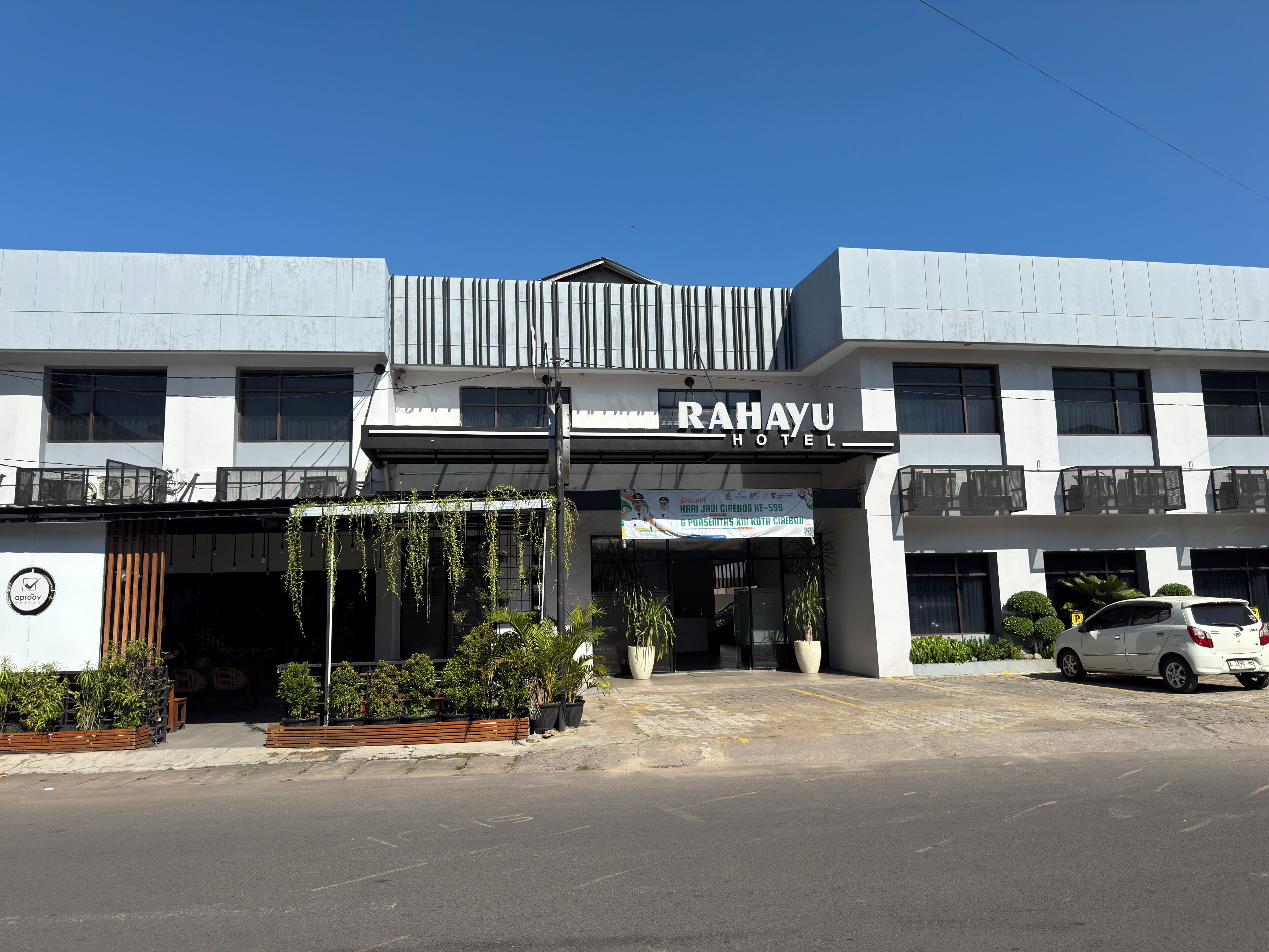 A modern building with a sign reading 'RAHAYU HOTEL.'