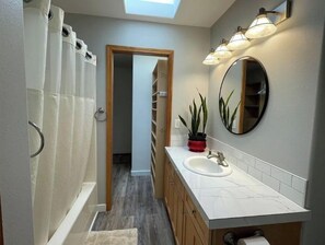 Combined shower/bathtub, towels, toilet paper