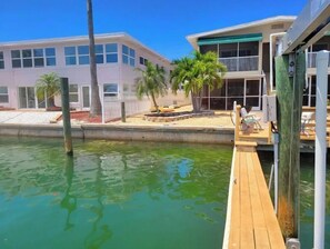 Enjoy waterfront access from the dock, with a balcony and outdoor seating area overlooking the calm waters.