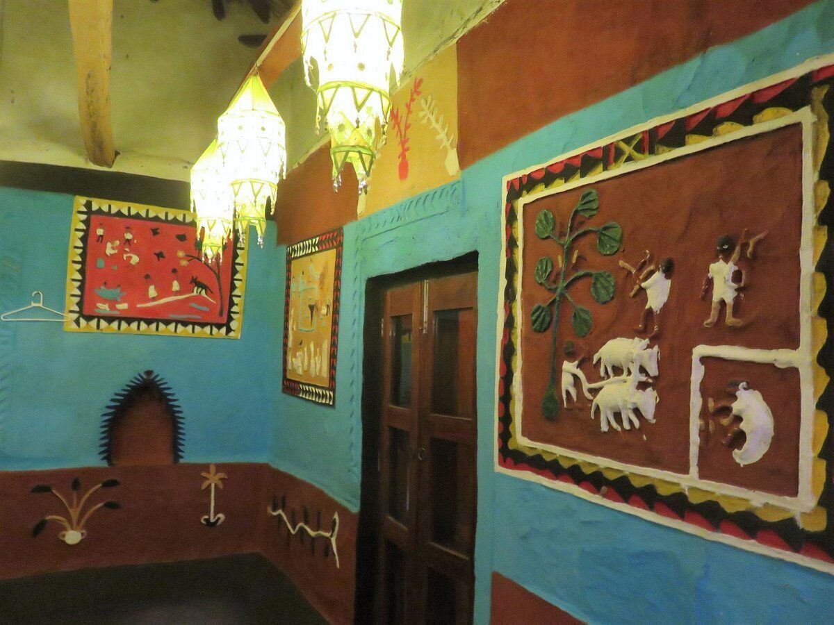 A room with colorful walls, a door, and decorative wall hangings.