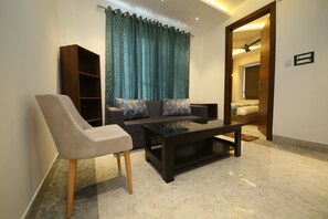 Premium Studio Suite | Living area | 32-inch LED TV with cable channels, TV, Netflix - Hotel Dream Inn (Narendranagar)