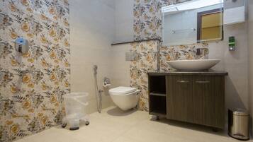 A bathroom with a toilet, sink, and shower.