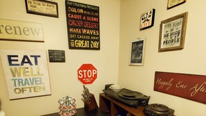A kitchen with a dining table, chairs, and various kitchen utensils. There are multiple signs on the walls with motivational messages. - Room-fall Room 3min From Yale, And Other (New Haven)