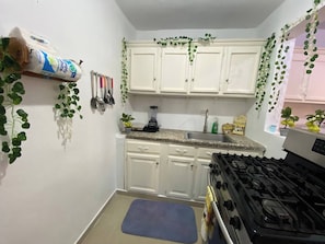 Apartment, 4 Bedrooms, Smoking, Patio | Private kitchen | Stovetop, coffee/tea maker, highchair, dining tables