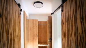 A narrow hallway with wooden walls and a ceiling light fixture. - Olimje Apartment with Private Sauna & Free Outdoor Pool - Gobi (Šmarje pri Jelšah)