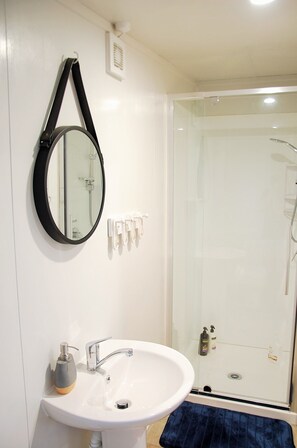 Shower, hair dryer, towels, soap