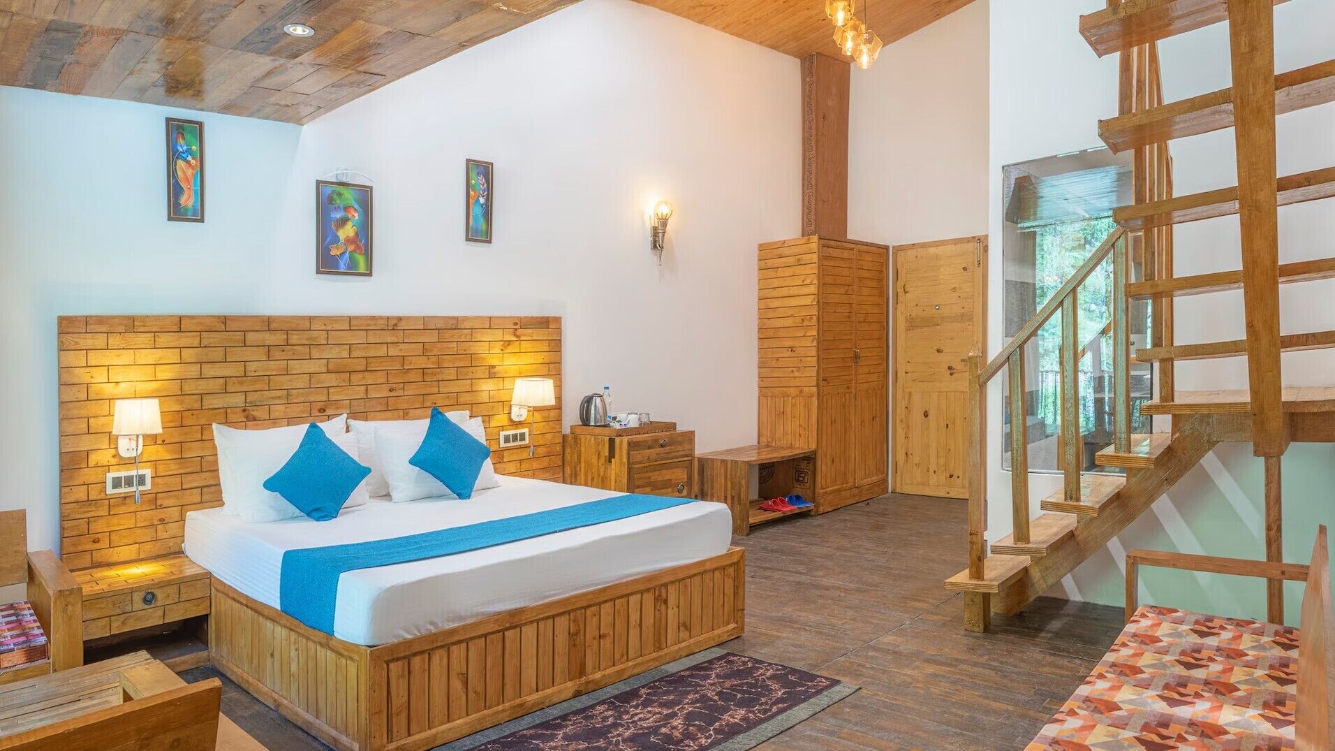 A wooden-framed bedroom with a large bed, bedside tables, and a wooden staircase.