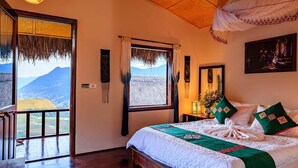 A bedroom with a large bed, a view of mountains, and a balcony. - Sapa Rosie House - Mountain Retreat (Sa Pa)