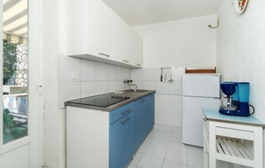 Enjoy cooking in this kitchen with a sink, stovetop, refrigerator, and coffee maker.