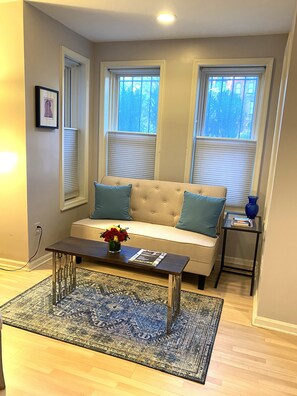 Cozy living room with a sofa, coffee table, and patterned rug.