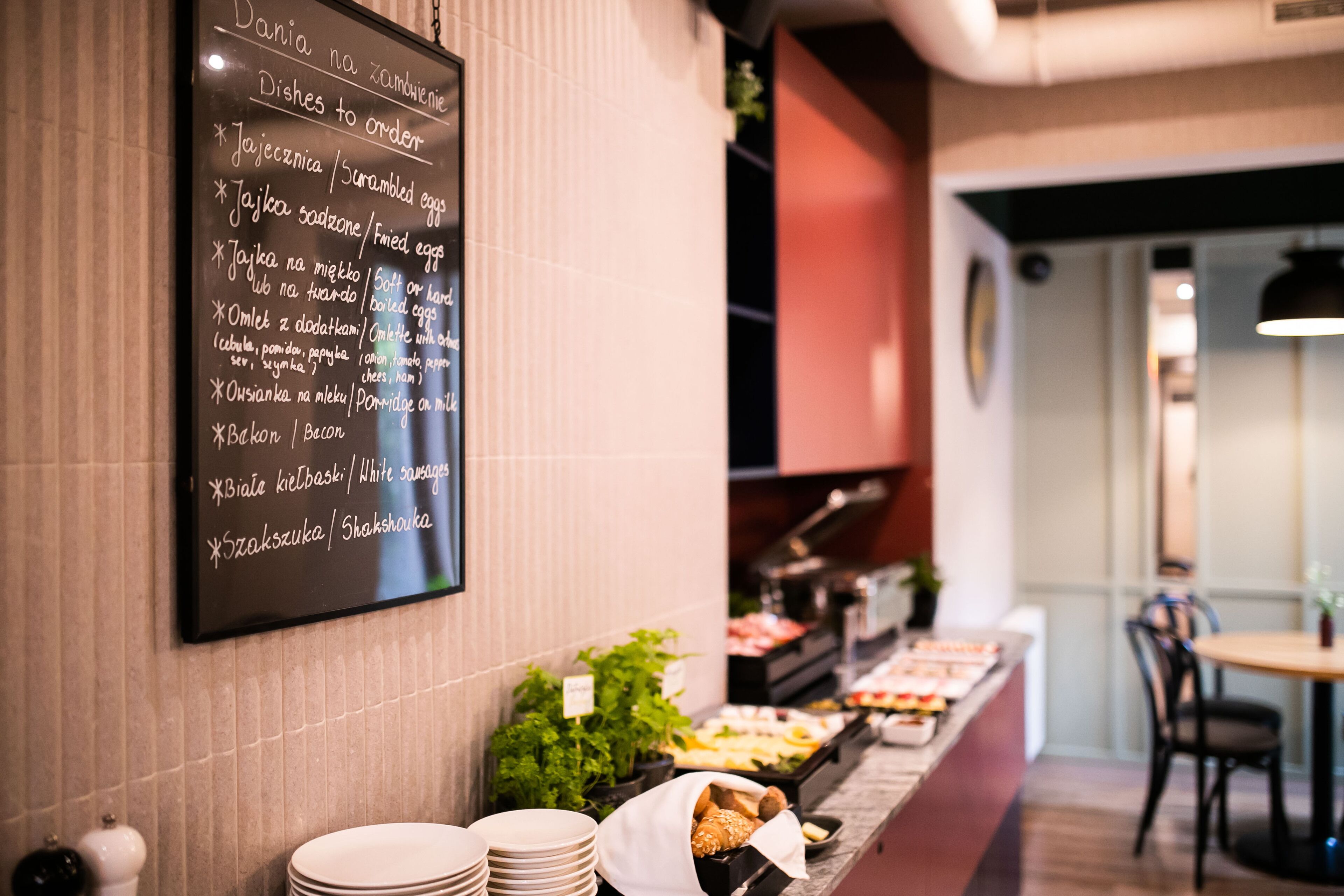 A buffet area with a chalkboard menu listing various dishes.