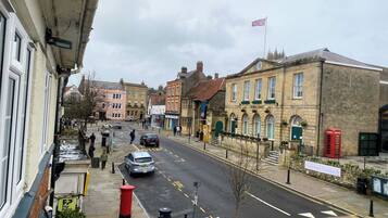 A street view with a pub named "The Old Hall" and a red telephone box.