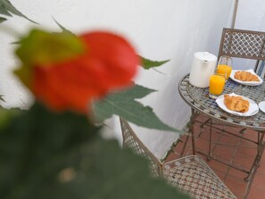 A table with a croissant, a glass of orange juice, and a bottle of milk. - Waters Watch (St Ives)