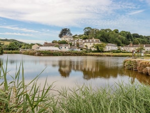 A riverside town with buildings along the water's edge.