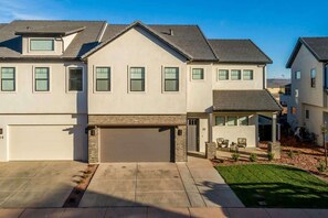 A modern two-story house with a garage, a covered patio, and a well-maintained lawn. - 65-66| Sleeps 38 * Pvte Pool *Hot Tubs* Fire Pit (Santa Clara)