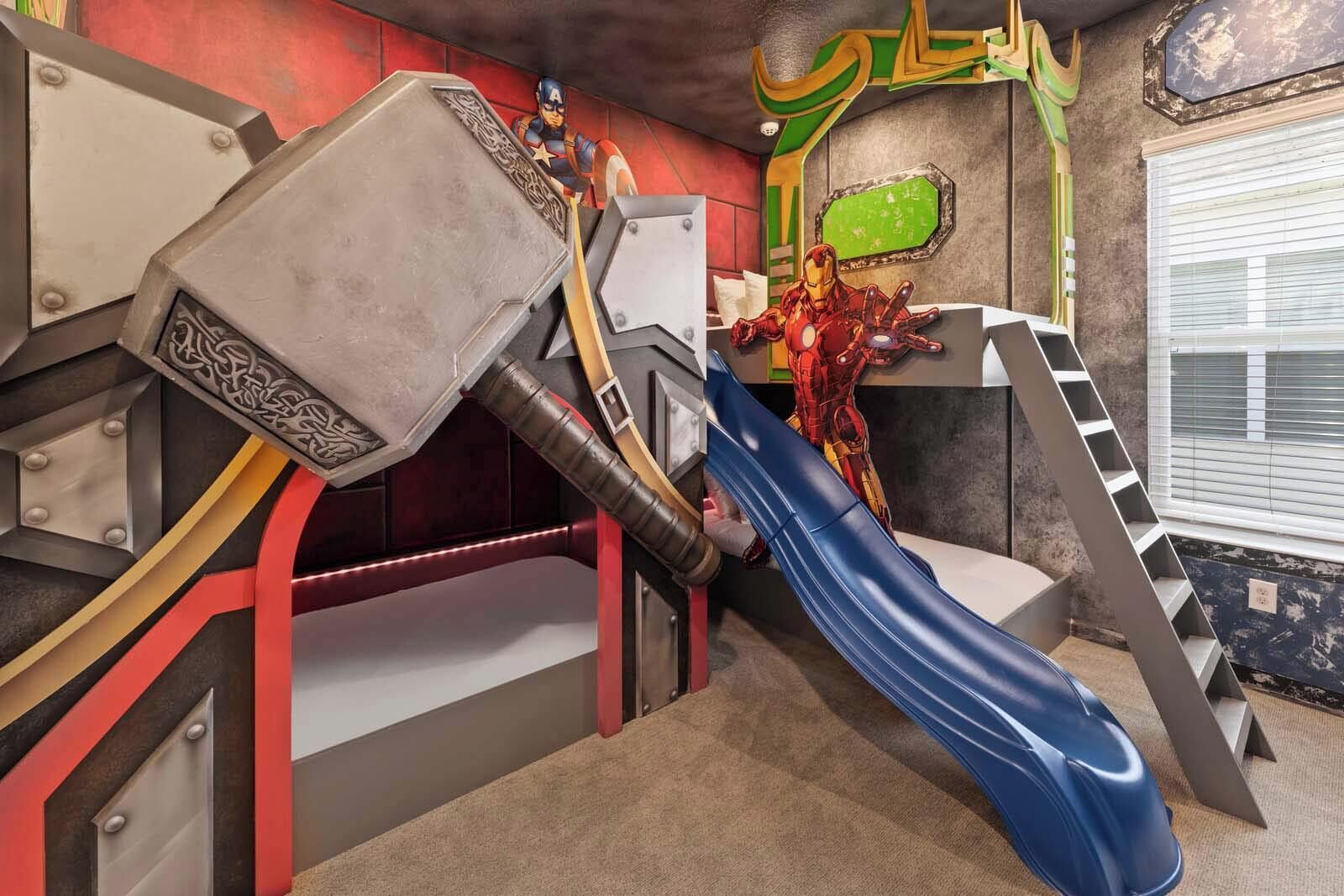 A children's play area with a slide, a hammer, and Iron Man.