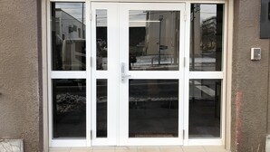 A building entrance with a double door and a small overhang above. - Cool-innOTARU (Otaru)