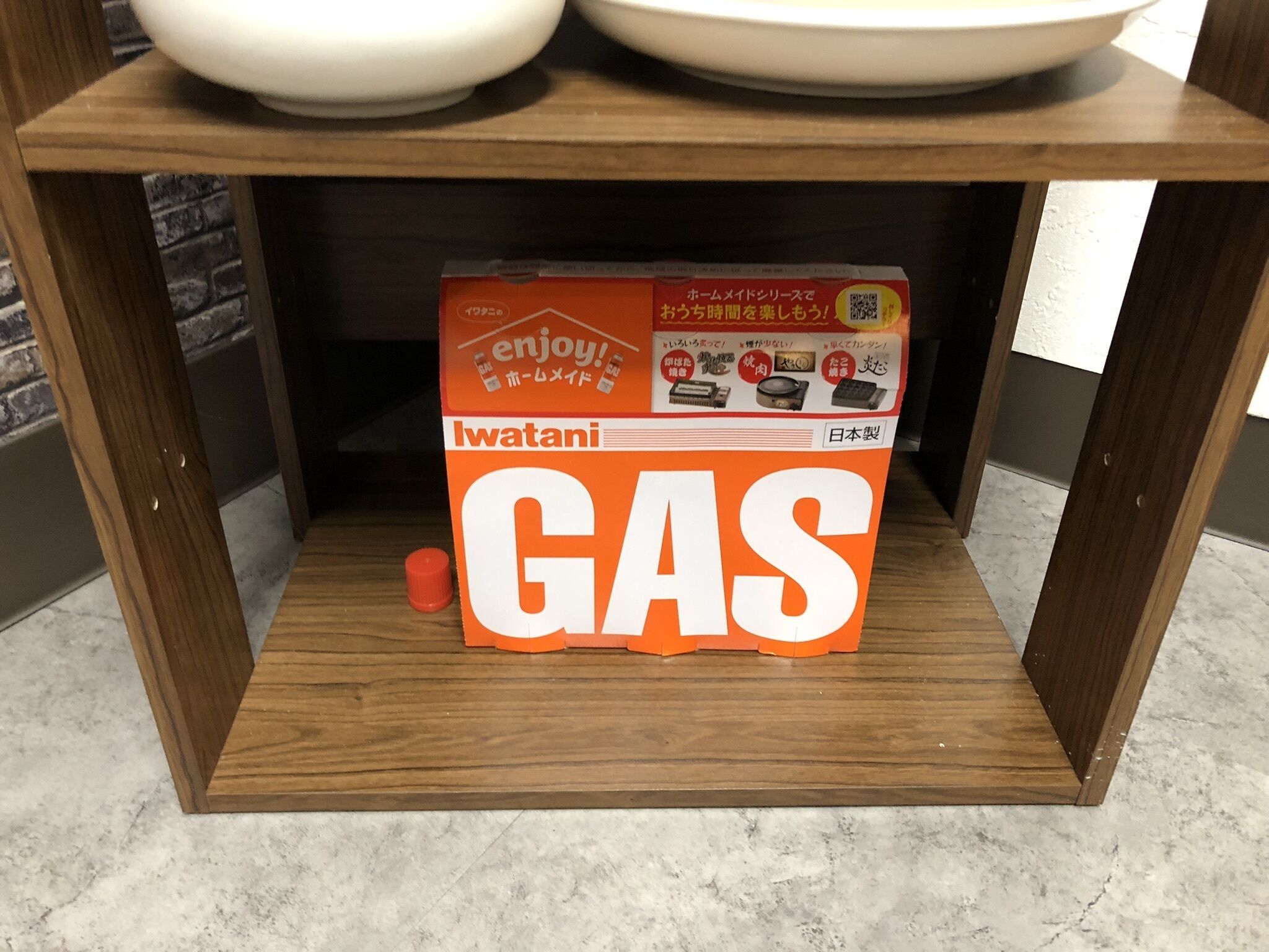 A kitchen shelf with a box of Iwatani GAS cooking oil.