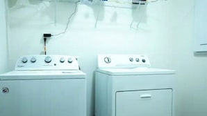 A laundry room with two white appliances, one with dials and one with buttons. - Gorgeous Entire Home In Greensboro!!!! (Greensboro)