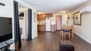 A modern apartment with a living room, a dining area, and a kitchen. - 1 BR with Ocean View - unit 1 (Fort Myers Beach)