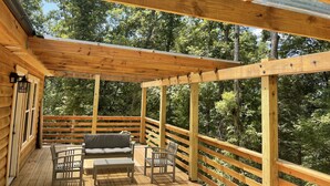 A wooden deck with a pergola, seating area, and railing. - Windrock Ridge Luxury Ethan Cabin: Ride-In Access, Sleeps 16. (oliver spring)