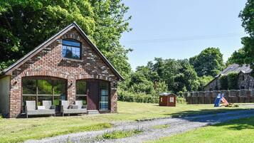 A brick house with a large window and a porch.