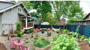 A backyard with a patio area, raised garden beds, and a hammock. - Alberta Arts District 2 private bedrooms/bathroom (Portland)
