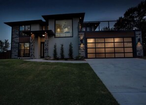 Stunning two-story home with a covered porch and beautifully manicured lawn.