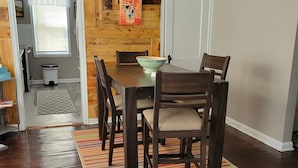 A dining area with a wooden wall, a ceiling fan, and a kitchen sign. - Clean, quiet and perfectly located in the city.  Near downtown. (Columbus)
