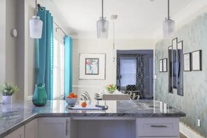 Enjoy cooking in this well-equipped kitchen with a sink, faucet, and ample countertop space.