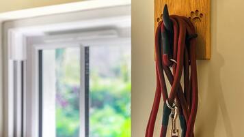 A wooden plaque with the word "WALKIES" and a dog leash hanging on it.
