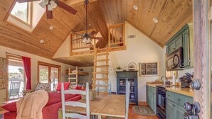 A cozy cabin interior with a loft bedroom, a dining area, and a kitchen. - Amazing rustic cabin with 450' of water frontage on Jackson Lake (Monticello)