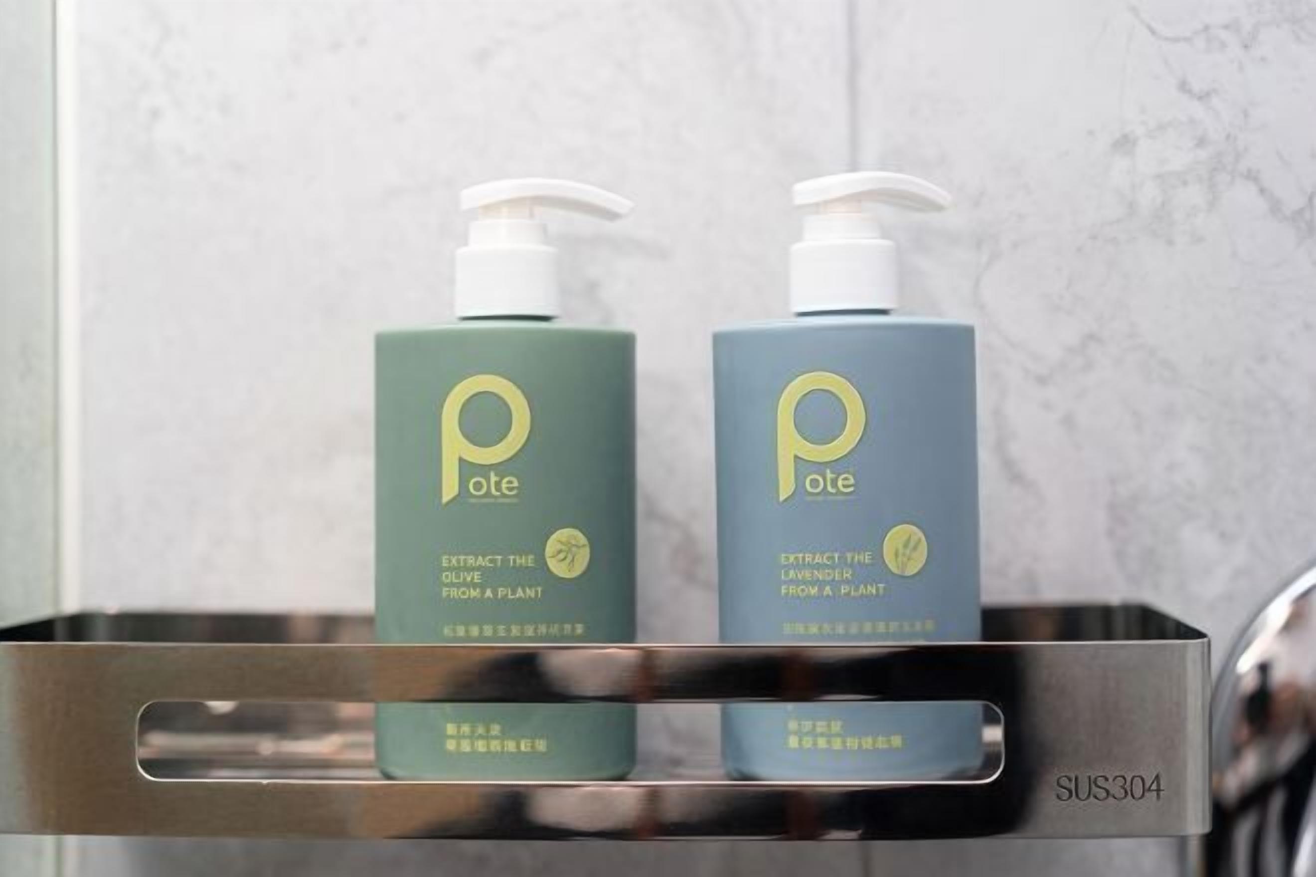 Two bottles of lotion with pumps in a metal tray.