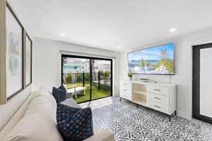 Suite, 2 Bedrooms | Living area | 55-inch flat-screen TV with cable channels, TV