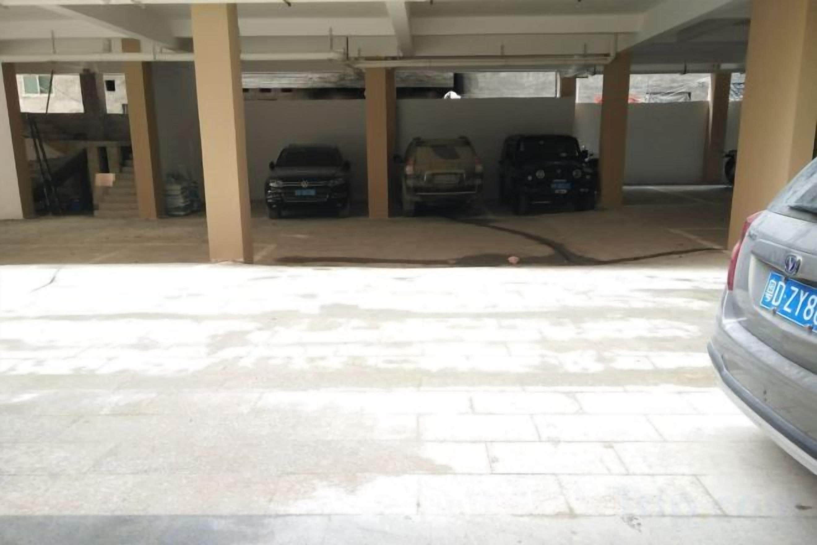 A parking garage with multiple levels and cars parked.