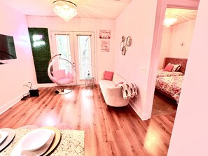 Relax in this inviting bedroom with a comfortable bed, stylish hanging chair, and large window.