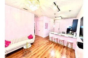 Relax in this stylish space with a sofa, coffee table, and bar area.