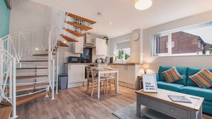 A modern apartment with a staircase, kitchen, dining area, and living room. - 1 bedroom accommodation in Acomb, near York (Acomb, near York)